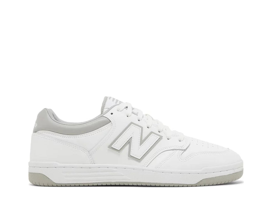 A white leather New Balance basketball shoe with gray accents.