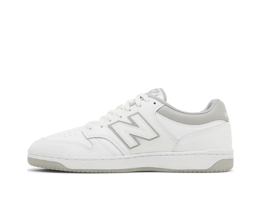 A white leather New Balance basketball shoe with gray accents.