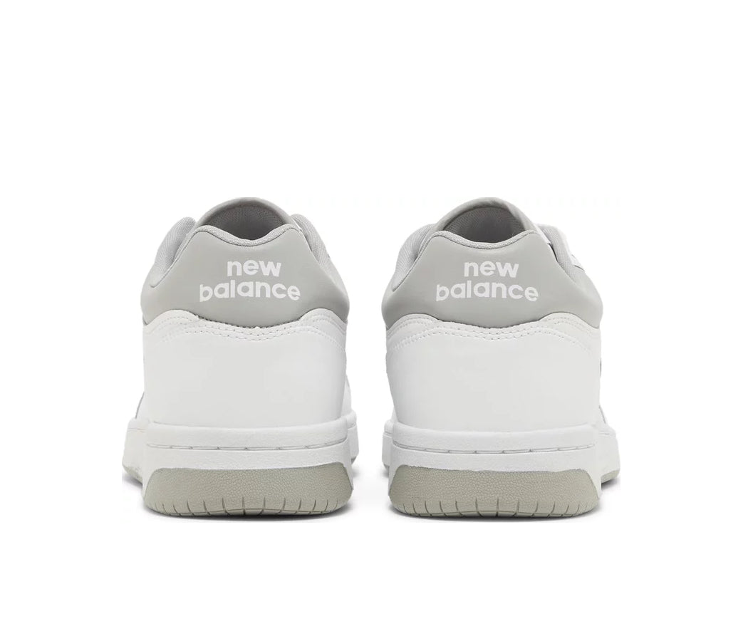A white leather New Balance basketball shoe with gray accents.