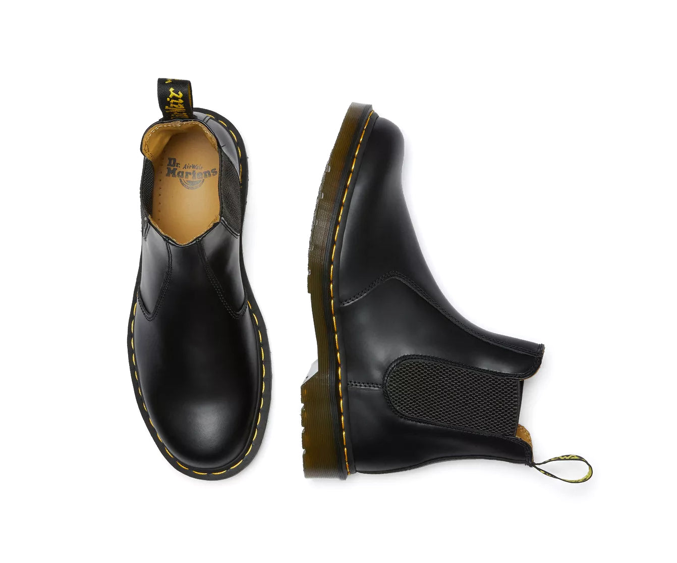 A pair of mid-ankle Dr. Martens black leather chelsea boots.