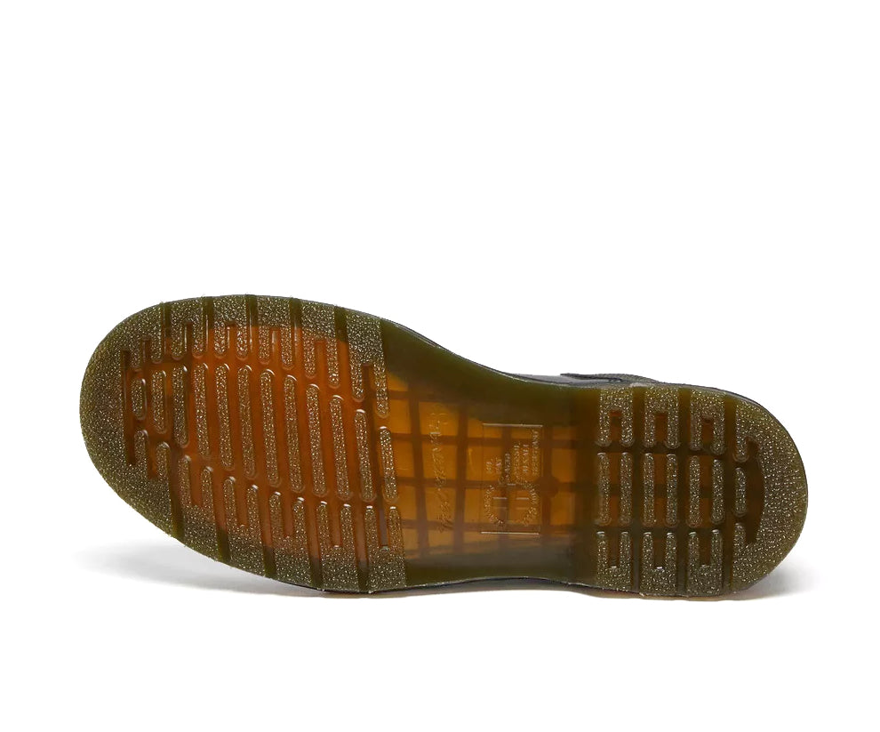 Sole of a mid-ankle Dr. Martens black leather chelsea boot.