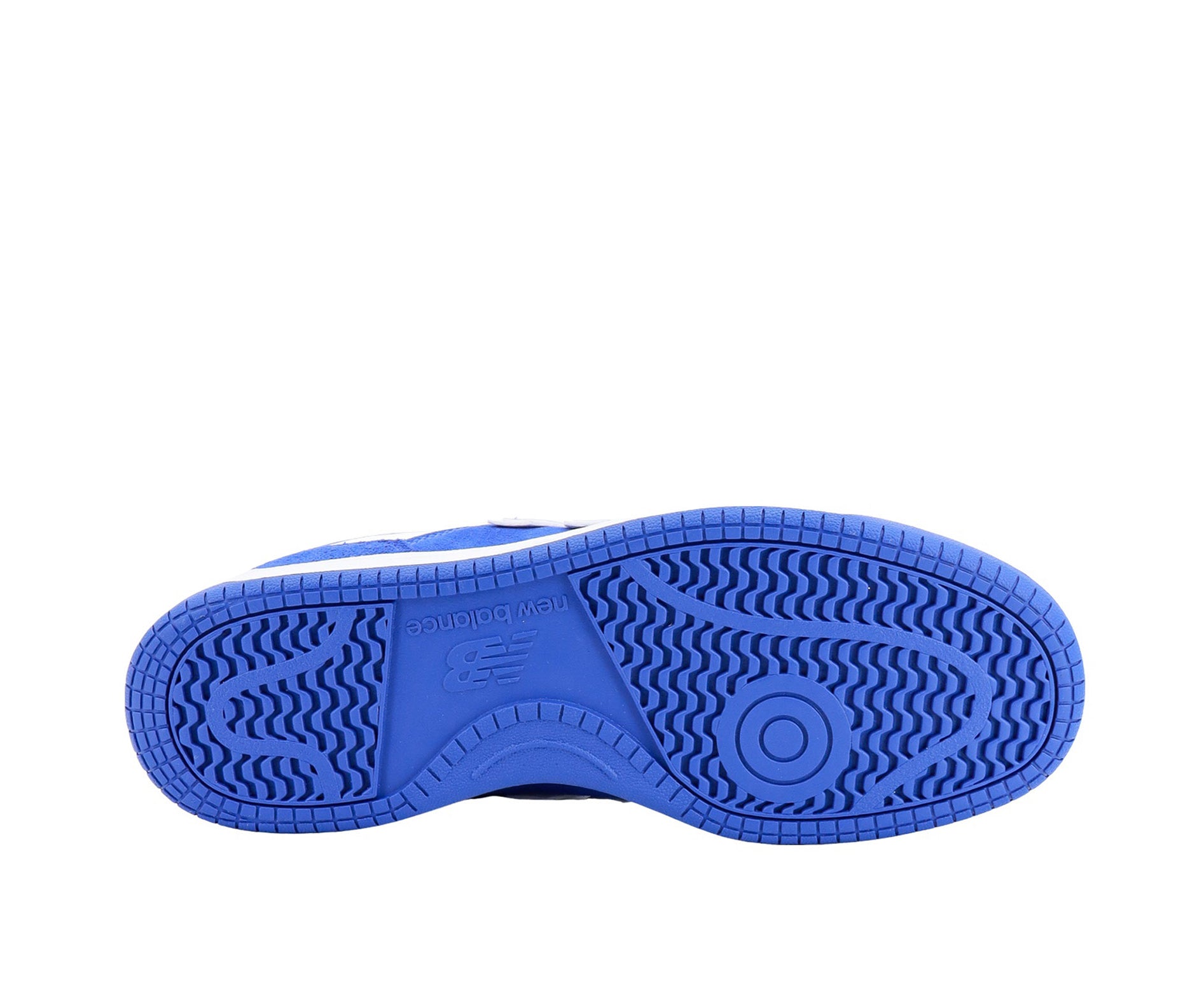 A white leather New Balance basketball shoe with royal blue suede accents.