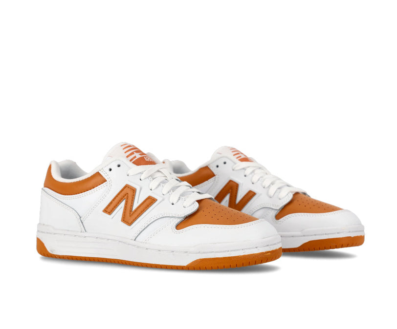 A white and orange leather basketball sneaker from New Balance.