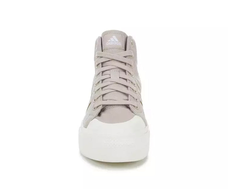 A taupe canvas high-top Adidas sneaker.