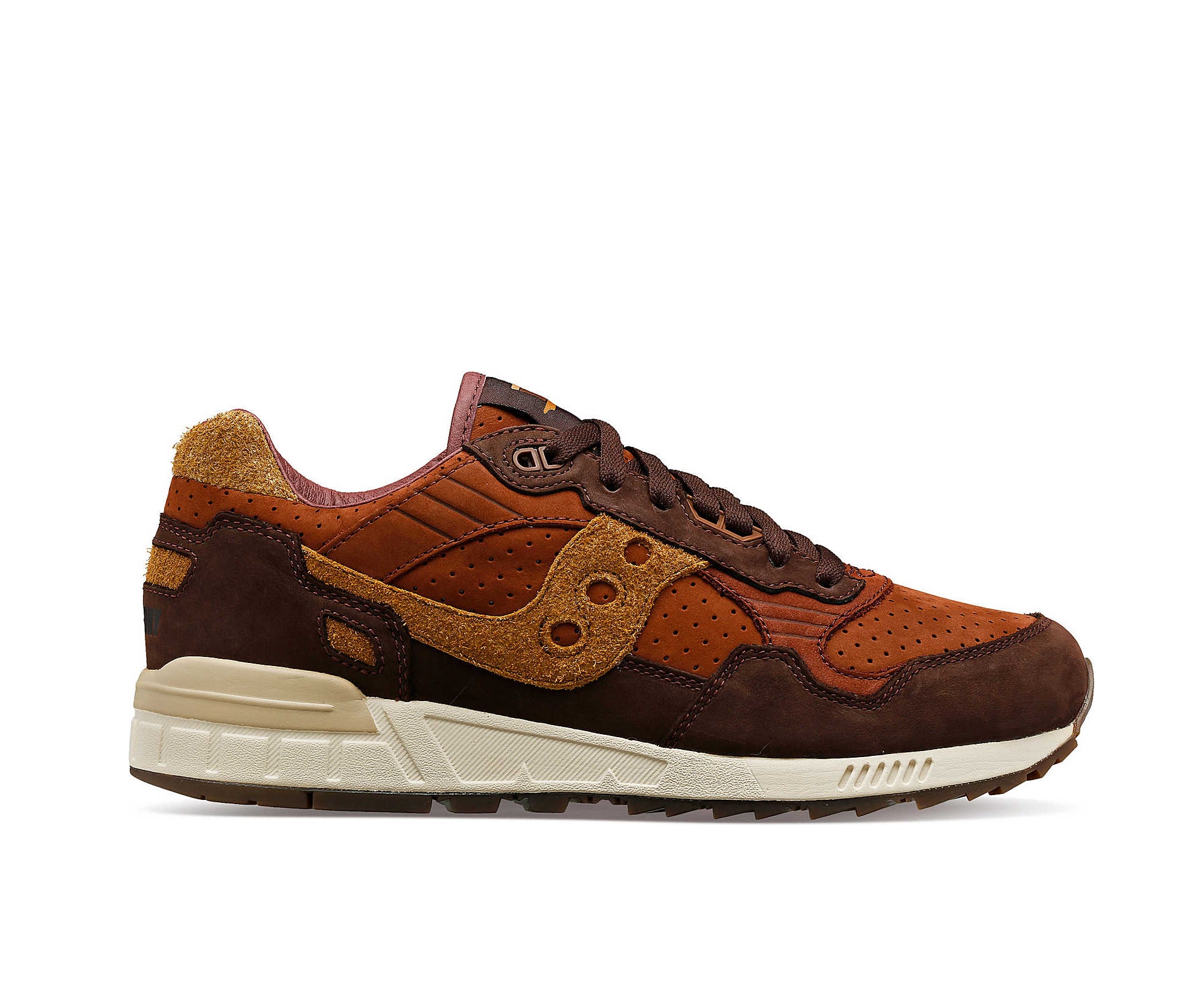 A suede low-cut Saucony sneaker in various shades of rich brown.