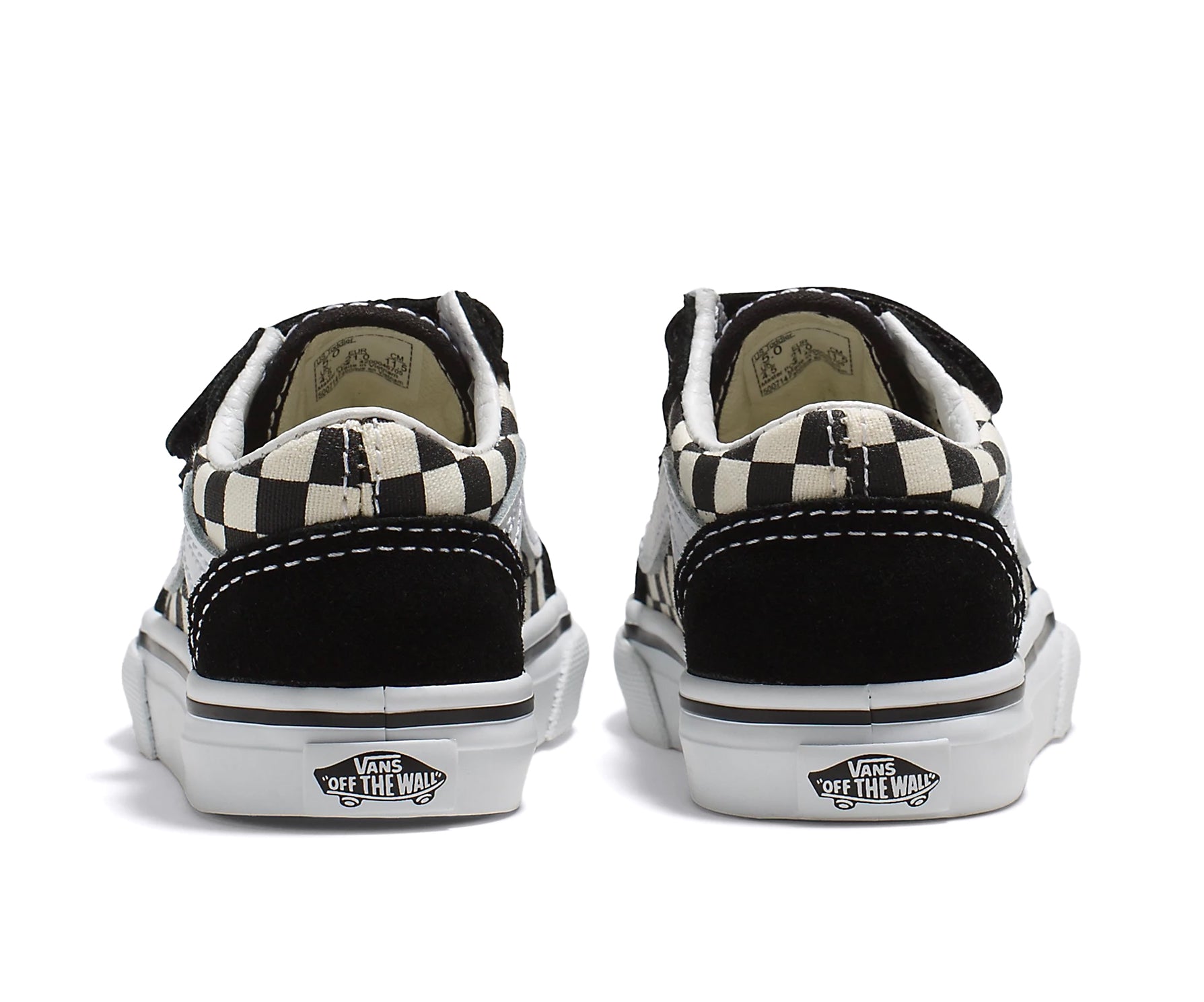 A checkerboard black and white canvas and suede kids' sneaker with velcro straps.