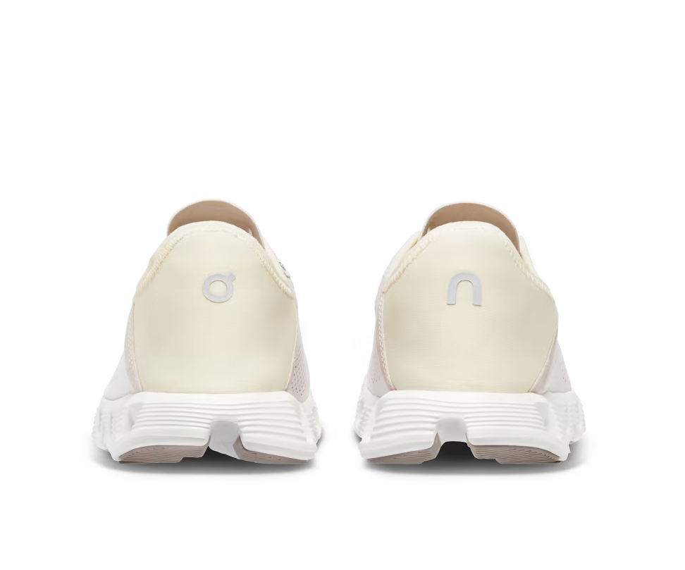 A mesh and rubber white and light yellow running shoe