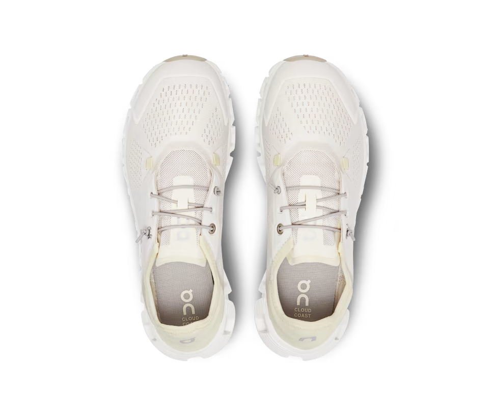 A mesh and rubber white and light yellow running shoe with elastic laces