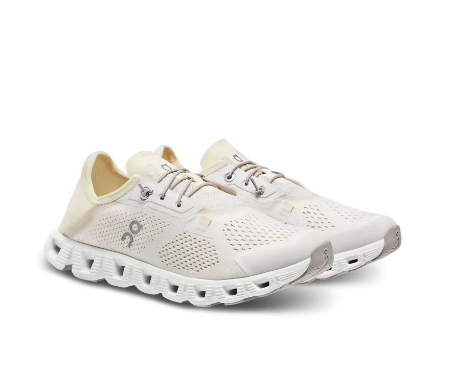 A mesh and rubber white and light yellow running shoe with elastic laces