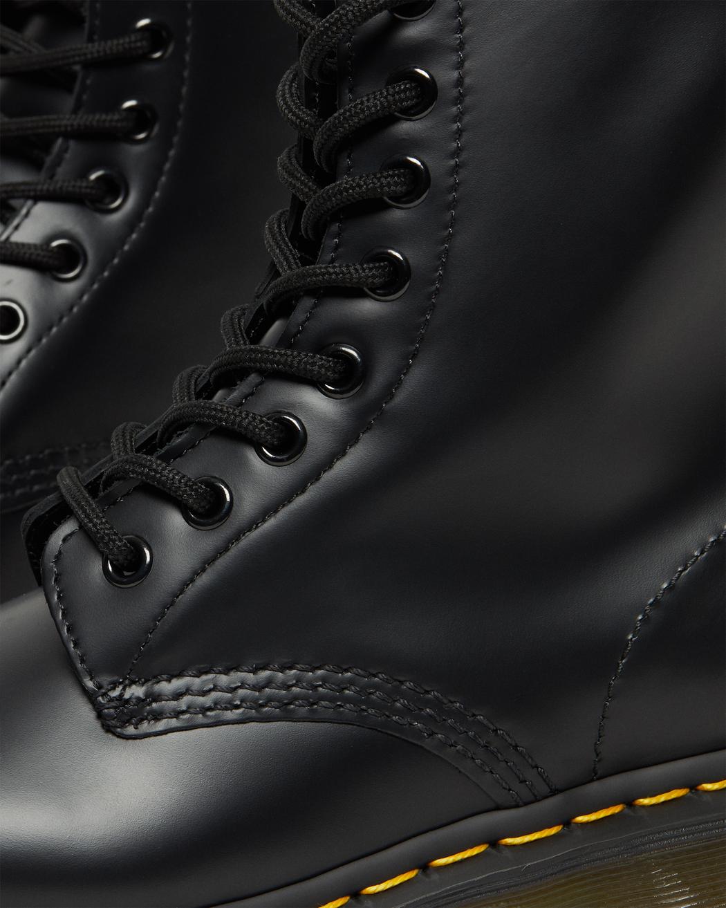 A mid-ankle height, laced, black leather boot.