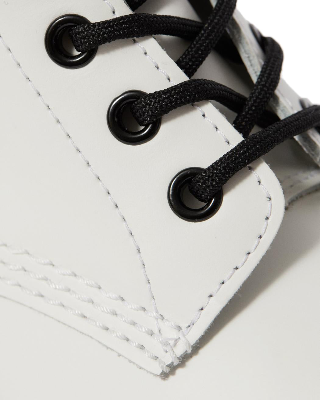 A white leather Dr. Martens ankle boot.