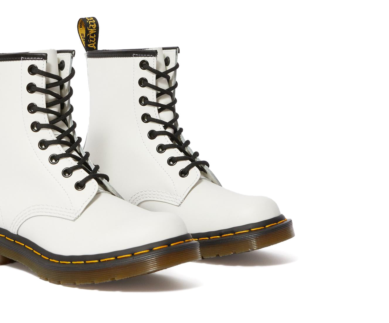 A white leather Dr. Martens ankle boot.