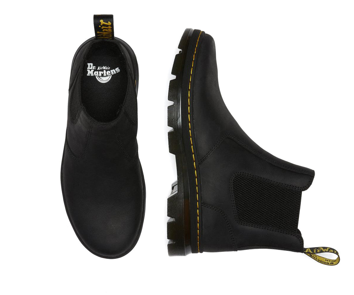 A black, softened leather chelsea boot from Dr. Martens with yellow accent stitching.