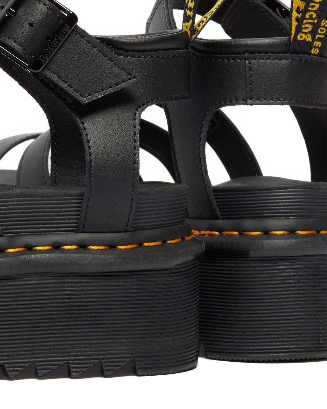 A black platform 3-strap sandal with ankle buckle from Dr. Martens.