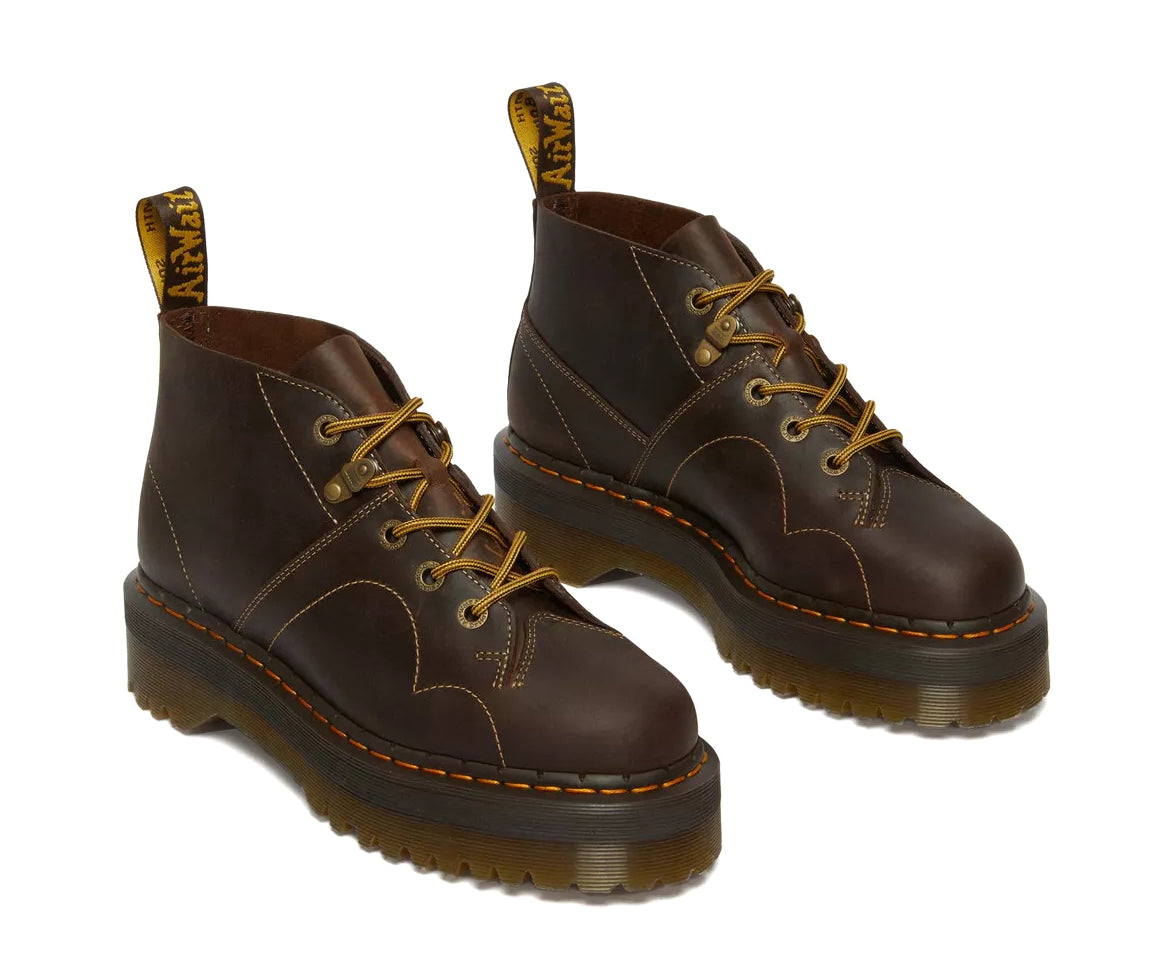 A dark brown leather chukka boot with yellow stitch accents from Dr. Martens.