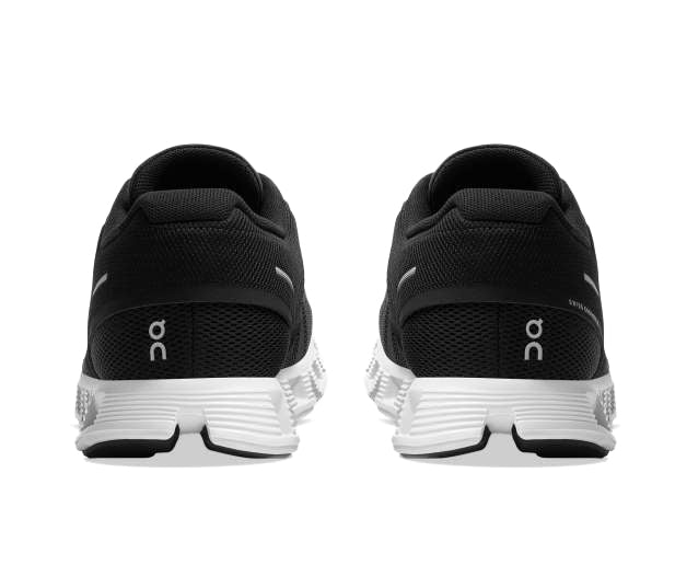 A black sneaker with white accents from On Running.