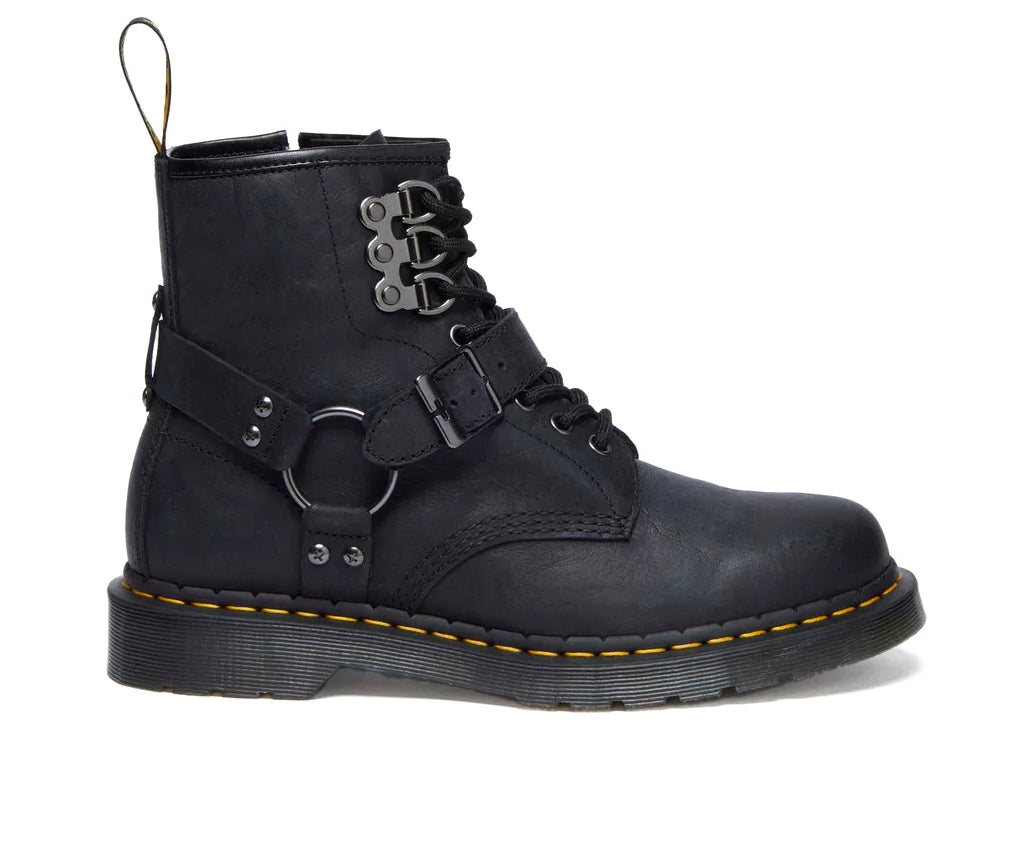 A black leather boot from Dr. Martens with additional straps and buckles.