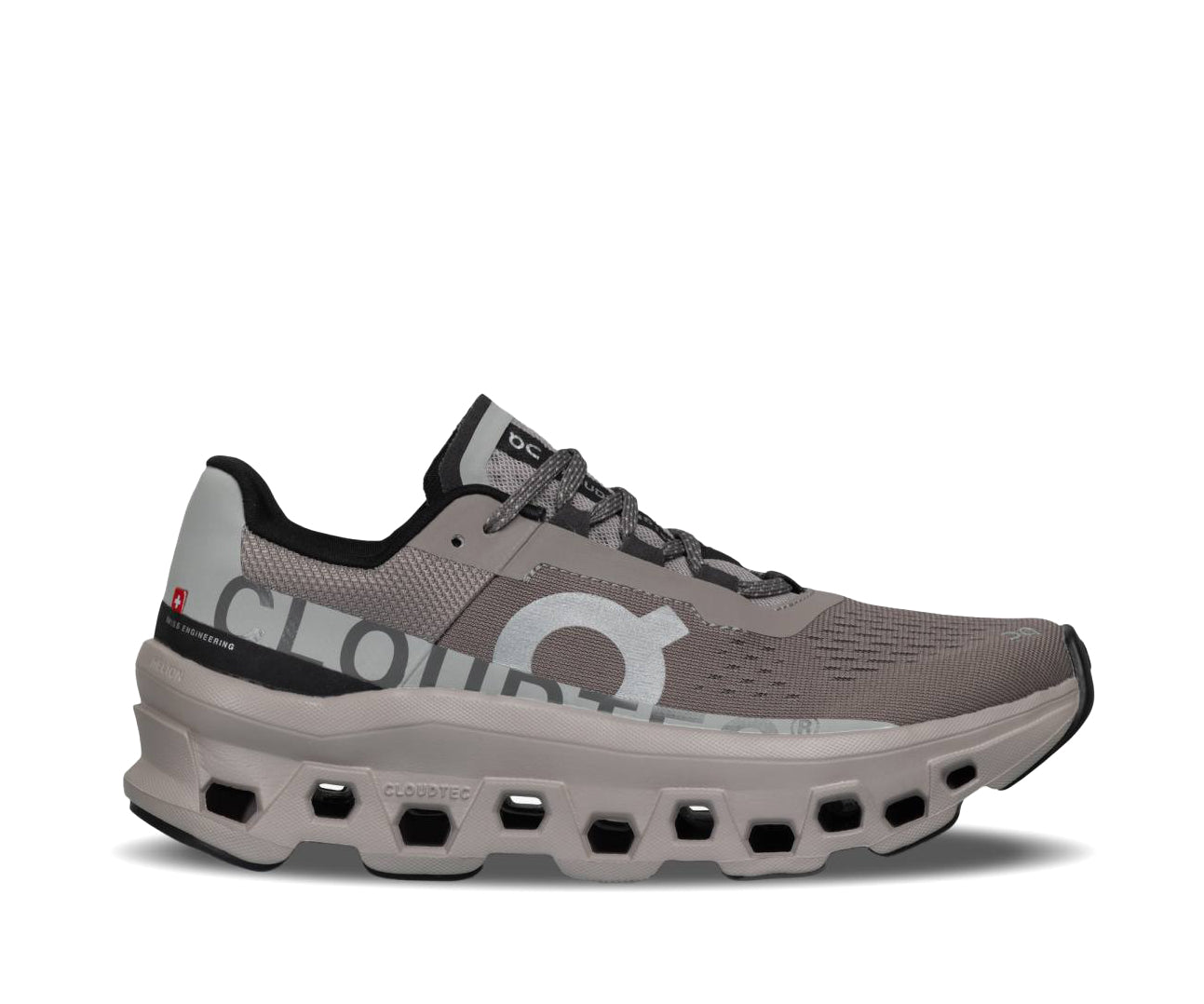 A grey running shoe with taupe and lighter gray accents from On Running.