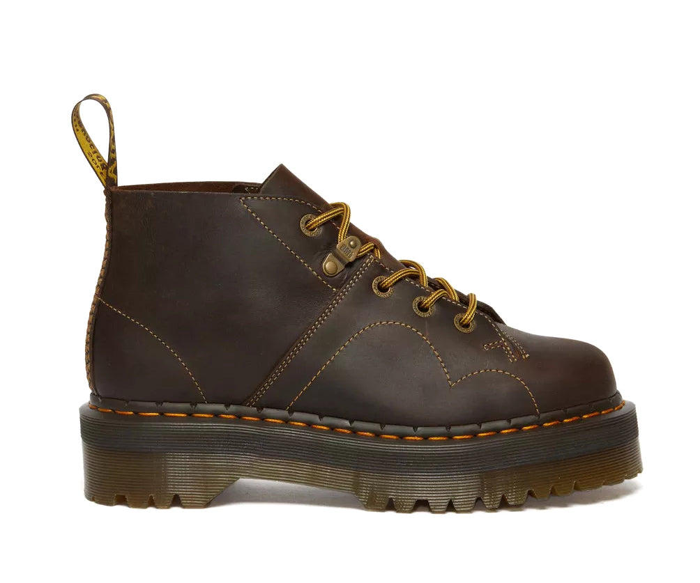 A dark brown leather chukka boot with yellow stitch accents from Dr. Martens.