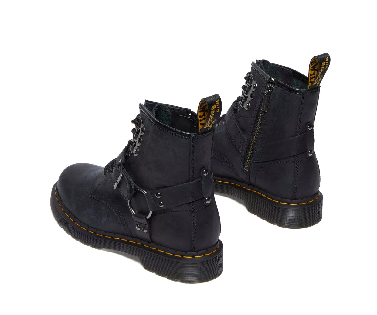 A black leather boot from Dr. Martens with additional straps and buckles.