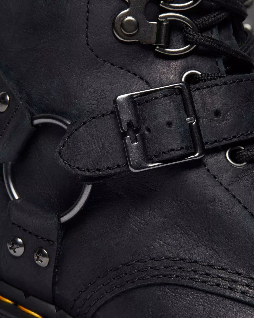 A black leather boot from Dr. Martens with additional straps and buckles.