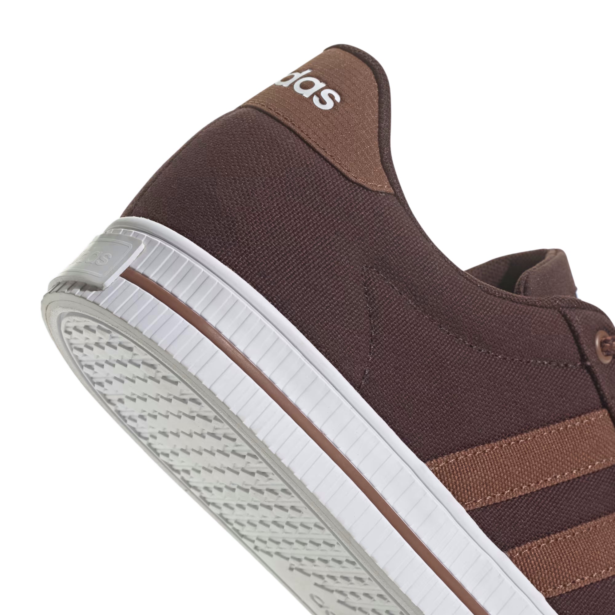 Brown canvas Adidas sneaker with lighter brown stripes and a white sole.
