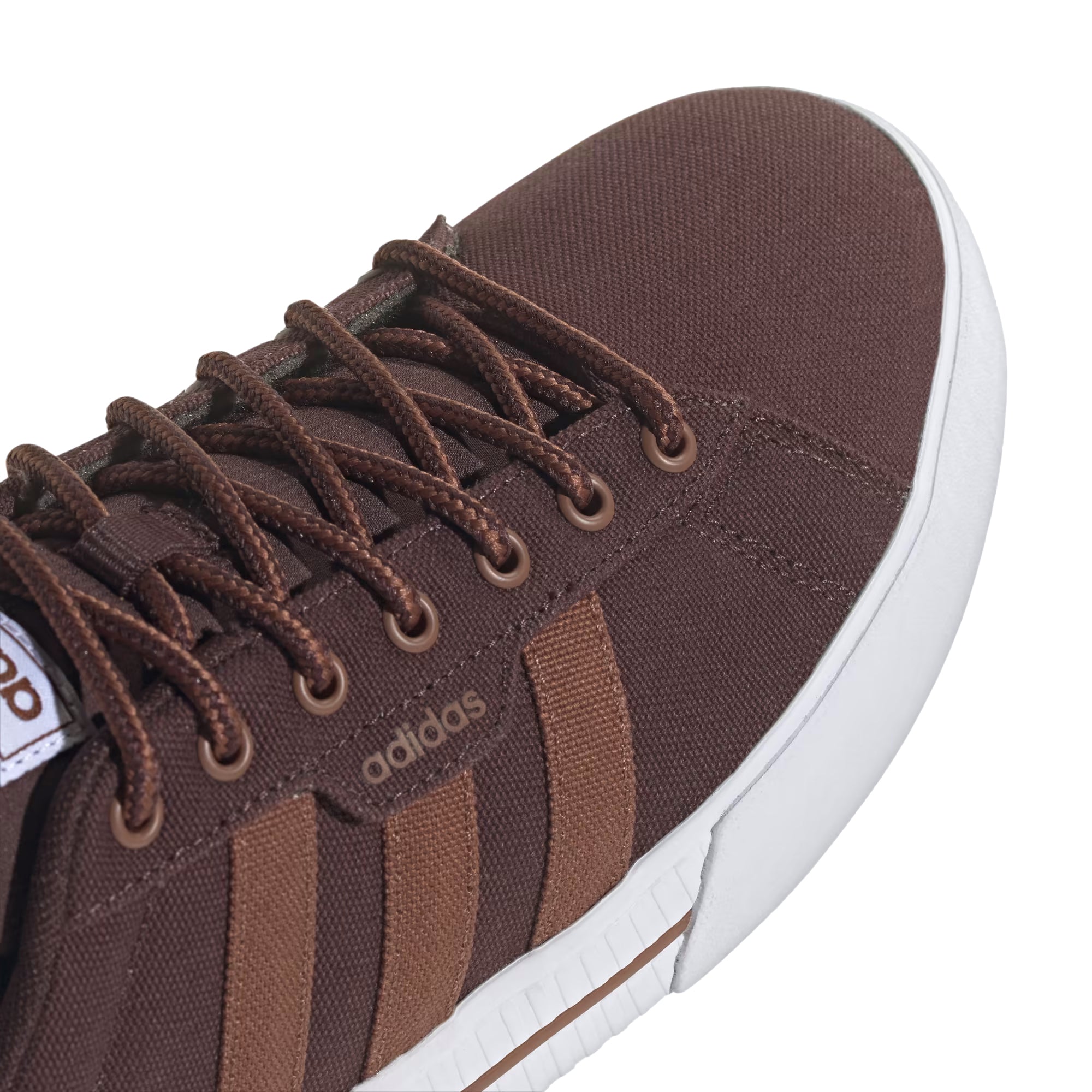 Brown canvas Adidas sneaker with lighter brown stripes and a white sole.