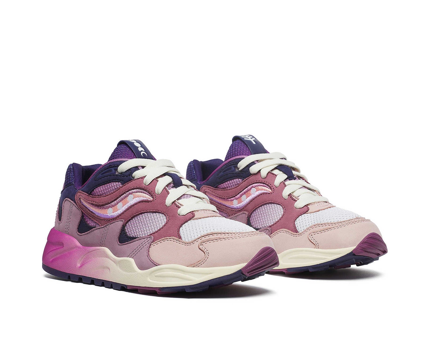 A purple sneaker from Saucony with dark blue accents and a magenta to white gradient.