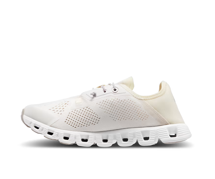 A mesh and rubber white and light yellow running shoe with elastic laces